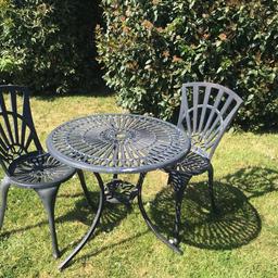 Cast Aluminium Bistro Set compromising of 2 Chairs and a Table
Few paint chips but otherwise all round good condition 
Table 69cm D x 66cm H