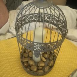 vintage grey birdcage, comes with decorative gold pebbles and large wax candle, can put anything you like in and decorate to your own tastes
can deliver