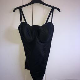 Stunning black body suit. Never worn.
In fab condition.