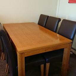 Solid Oak and veneer dining table
Silver feet
160cm x 90cm x 75cm high
Table is in very good condition 
6 Brown chairs, slight blistering/ cracking on some
Collection only
Also selling matching items