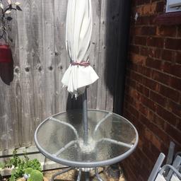Garden table and umbrella.glass top.no chairs and I’ve used a pot for the umbrella base.table has no chips but needs a good clean but the umbrella isn’t great.collection only.