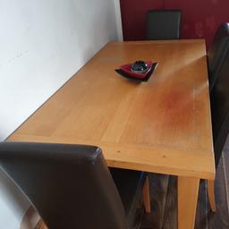 solid dinning table with 4 brown faux leather chairs measurements are 64 inch length width is 34 inch
collection only