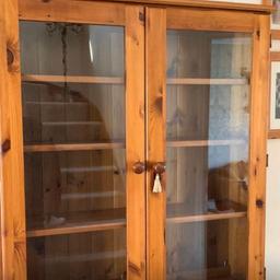 Solid wooden unit with glass doors.
107cm high, 100cm wide and 28cm deep