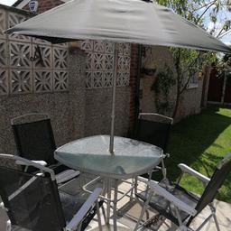 Perfect for outdoor summer dining / alfresco dining.

Table is square with curved edges.
Measures 85cms x 85 cms
Clear etched table - see photo

Chairs are metal construction with mesh seating.

Comes with an umbrella (free). It is slightly broken but still works perfectly.