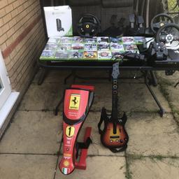 Loads of games , 3 steering wheels, steering wheel stand , guitar, 2 remote control all cables included