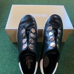Genuine Black leather ladies slip on sneakers by Michael Kors. White soles. Silver studded eyelet detail. Only worn a few times and in great condition with original box.