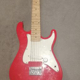 red unisex st style electric guitar. few minor scratches, all strings work. has no amplifier.in good condition. with case.