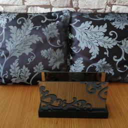Black and silver theme home accessories. 2 cushions and a tealight holder.
The tealight holder has glass sides and wooden base.