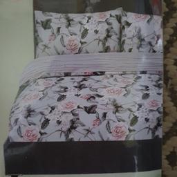 Brand new king size duvet cover set, duvet cover & two pillow cases, new and sealed. Grey and pink floral with striped reverse. Collection only from Chilton.
