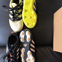 Size 12 black and Size 12.5 yellow kids football shoes with studs.