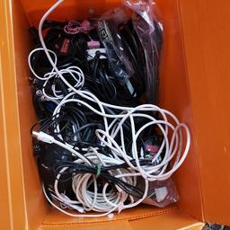 Box of surplus wires for phones, laptops, music centres and tvs. From aerial wires to scart leads