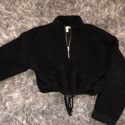 Black fluffy zip neck Topshop jumper with tie at waist, slightly cropped 
Super comfy and cute
In great condition only worn once 
Size 10 
Can post