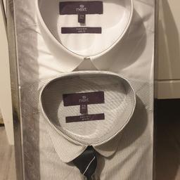 Brand New.
2 Pack Mens Shirts.
White and Grey Pinstripe with black tie gift set.
Packed in giftbox.
Size: 15"R - Slim fit.
Originally bought for £32