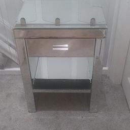Glass Bedside Cabinet with one drawer and one glass shelf. Crack to the front right side of Cabinet and to the top right hand side. Please see pictures for details. Lovely piece of furniture. Pick up only.