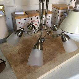 There’s 5 lights on each one they are antique gold with frosted class shades excellent condition selling due to decorating they cost £45 each 2 years ago selling for £15 for both