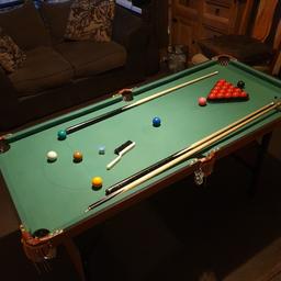 A great little table for beginners to introduce them to the game. It was my son's first snooker table & from this he learnt how to play. A couple of stains near blue spot, few specs of glitter, but overall as you can see it's in very good condition. Comes with 2 sets of balls (snooker & pool), 2 cues, triangle/chalk/brush, & a rest. It is collapsible so it folds flat for storage. 4 ft 7" x 2 ft 1" (55" x 25") Cleaned & ready to go.

Heavy item so it needs to be collected from B21, no delivery.