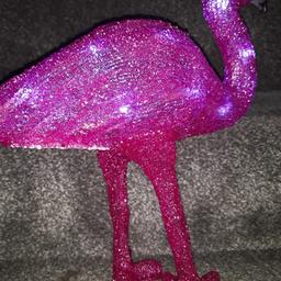 a beautiful light up pink flamingo ideal for any where .in house or garden  stands 1ft tall  .including bran new batteries. it looks stunning at night .its a steel .