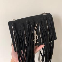 Saint Laurent small Monogram Crossbody crafted in black suede, featuring unique silver-tone chains and black suede fringe throughout, finished with metal YSL logo along the front. RRP £1950

Chain-link shoulder straps
Concealed magnetic closure
Interior slip pocket
Suede
Fabric lining
Silver hardware

Very Good Condition no visible wear and tear. Comes with dustbag. Bought from Sellier Knightsbridge

Length: 6.6" (17 cm)
Height: 4.3" (11 cm)
Depth: 3.5" (9 cm)
Strap Drop: 23" (58 cm)