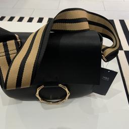 Brand new / never used and still with label Marks & Spencer stylish ladies handbag for sale. Black colour with beige strap. Pair of shoes added to one picture only as a reference to size of the bag, not part of the deal. Happy buying.