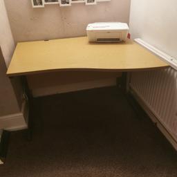 Large computer desk with curved front. Wire traps at the back with matal legs. Desk surface is free from scratches. Does not have edging on the two sides only on the front. It is quite heavy but easy to assemble with a few screws)