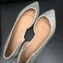 Flat slip on glittery silver shoe.