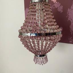 striking mini chandelier. Constructed from chrome rings that have cascading acrylic beads and droplets falling from them, this ceiling pendant will add a touch of glamour to any home.
Pink/ light purple colour
Used but in great condition.