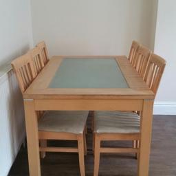 Dining table with glass top and six chairs with cream cushion.  Used but in very good condition.