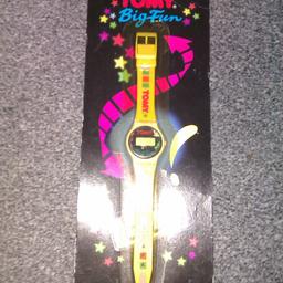 tomy big fun watch, this is new never used or taken from the sealed packet, the packet does have damage and discolouring from storage over the years, the watch face is white and yellow straps , just the bubble has discoloured on the packet.. RARE item? cannot find another for sale in my searches.