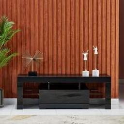 - Visit us on cintsandhome.co.uk -

Modern High Gloss TV Stand Cabinet with LED Light for 32 to 65inches
Size: 110CM/51”*29CM/13.8”*47.5CM/17.7”(L*W*H)
Color: Black
Material: E1 particle board and MDF
NOTE: High Gloss Front , Matt Back

Features:   
51inches TV Stand Cabinet: contemporary tv stand cabinet with LED light.

Modern TV Stand Cabinet with Storage Drawers and Glass Shelves
Wooden High Gloss TV Stand Storage Cabinet: this tv storage cabinet is made of 16mm E1 particleboard, the front panel and drawer of the sideboard are both high-gloss surfaces, with bright gloss.

Postage time is usually between 3-5 working days.