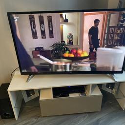 50 inch bush smart tv with stand 8 month old . Stand lights up has 2 glass shelf and grey draw and surround sound system
