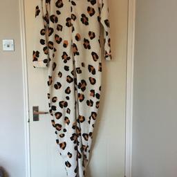 Woman’s leopard print all in one onesie. Never worn. Built in socks. Woman’s small