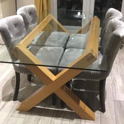 A heavy glass top dining table CHAIRS NOT INCLUDED 
Solid wooden frame with a thick glass top
It does have scratches to the top from use but nothing major. Still looks Lovely & fully functional.

Can deliver locally for a small change

£90