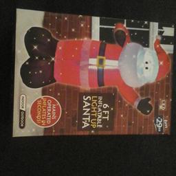 6ft inflatable light up santa, never used, including pegs and cord  cost £30 sell £25, collection only