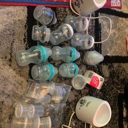 Tommee tippee feeding bundle. X2 bottle warmers, numerous milk / food storage pots, 6 normal bottles and 4 anti colic bottles.