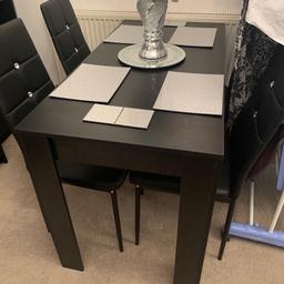 Black dining table bought from Mano Mano for £80. Arrived with small dent/chip on side of table top and has a dent/crack in one side of one leg (my fault). Since I have had replacement parts arrive and paid for my mistakes I have this table for sale as is. Damage could easily be covered and hidden. This is a small family dining table measuring 120x60cm. All damage can be seen in pics. £40 ONO. Table only, chairs not included. Local delivery Possible.