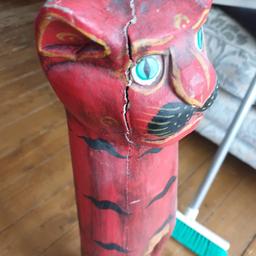 we have here a wooden cat ornament. there is a crack on the head. been there over 8 years!! 80cm high
