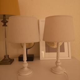 Barley twist wood lamps with cream rough linen shades.