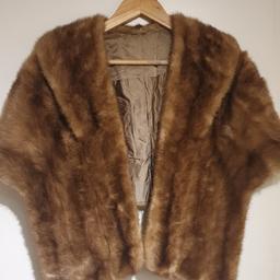 Brown Faux fur stole. Silky lining. This one is slightly tailored so it fits on the shoulders slightly and then hangs down. Mid length - each side reaches down 55cm. Lovely cosy and decadent addition for winter outfits!