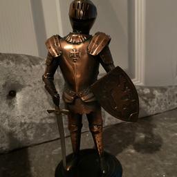 Bronze coloured knight with sword and shield 
Slight mark on rear leg 
New unwanted gift 
Just been in a box 
Face shield lifts up 
Collect CM3 or can post 
Copper coloured 
See my other items 

From a smoke free home