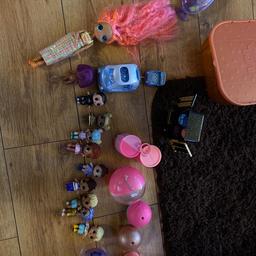LOL bundle including big OMG LOL doll, she has a slight burn to back of head however hair down covers this and does not affect doll in any other way. There is a large case and a small case with some accessories in, 12 dolls in total cost around £110 for 11 of them and the large OMG cost £32