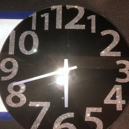 Black glass wall clock 

The numbers are silver glitter 

Excellent condition 

Collection only