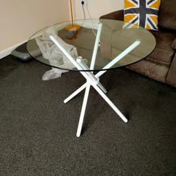 glass dining table with white legs. It was purchased last week on Wayfair but don't need it now. It has never been used. Sits 4 people. Tempered glass. Paid over £100
