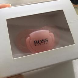 Brand new. Unopened hugo boss baby dummy in Pink.
Lovely gift for a newborn girl.