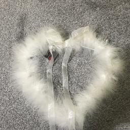 Heart shaped feather wall decoration, battery operated, good condition.