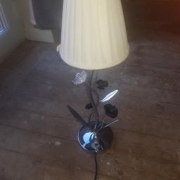 pair of bedside table lamps. white shades. white plastic Rose's and black metal Rose's. in very good condition.