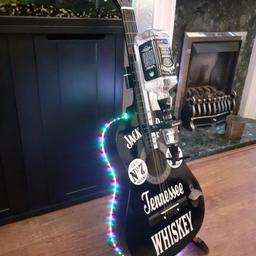 Jack daniels Guitar Bar. Condition is "like New". Full-size acoustic guitar with multifunction lights remote control included bar optics and bottle opener can be wall mounted or looks cool on a stand bottle and stand not included

￼