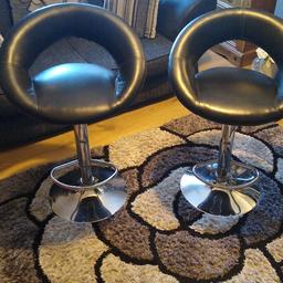 two black faux leather bar stools in good condition, hydraulic working raise and lower height of stools, only a small mark on one stool as shown in picture.