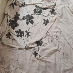 x2 reversible double duvet sets, 1 white with black flowers and grey detail, 1 black and grey paisley pattern