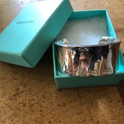 Tiffany style bangle , stamped 925
Couple of scratches on but not really noticeable 
Looks the part but cannot guarantee authenticity so selling in the style of and price reflects that 
Complete with box