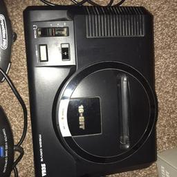 Sega mega drive + sonic 2 game.

The megadrive is in full working condition, comes with official plug and aerial adapter.

Sonic 2 is also full working condition and has the booklet in box.

Comes with 5 controllers 1 is official and came with console